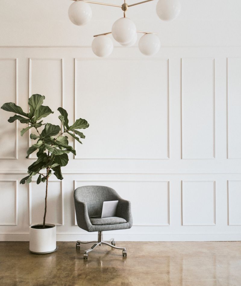 Calming therapy office space in New York, NY with grey chair and pretty indoor plant