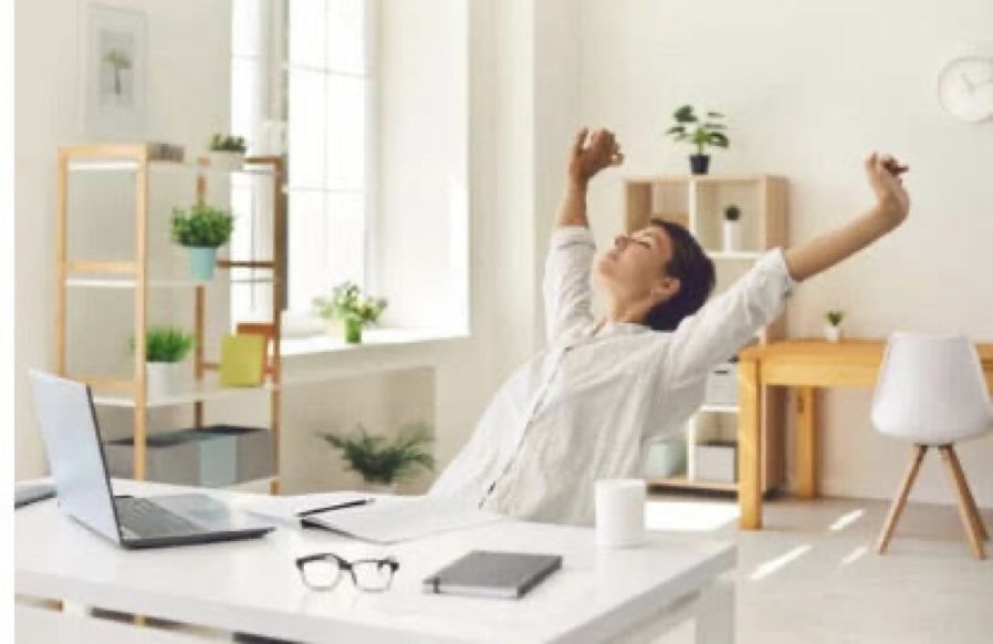 woman stretching at desk learning healthy ways to move through feelings of anxiety