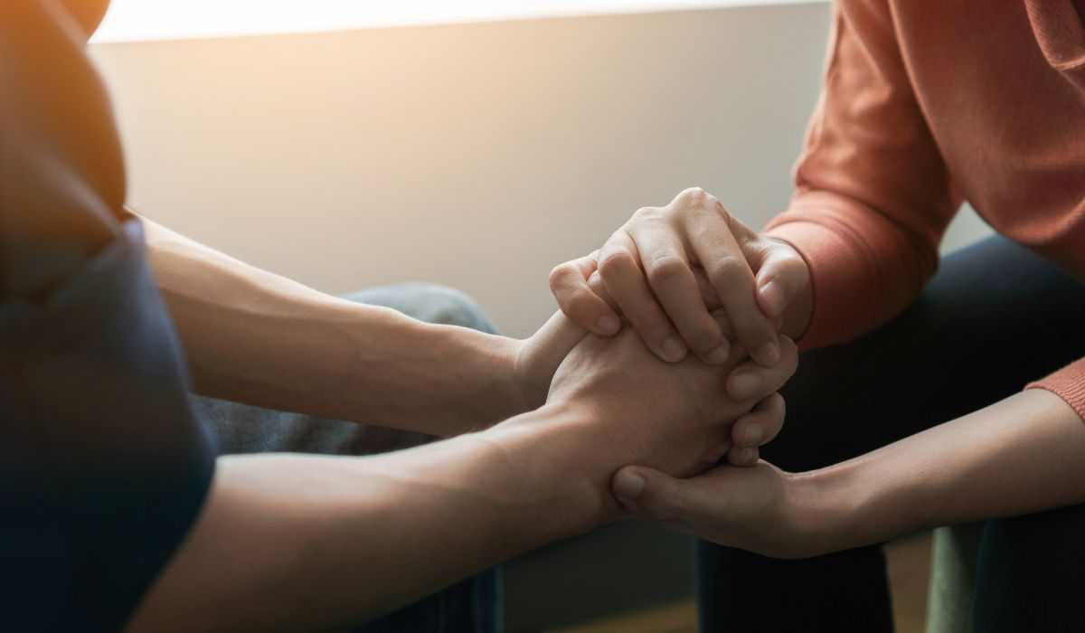Person comforting perfectionist, holding hands