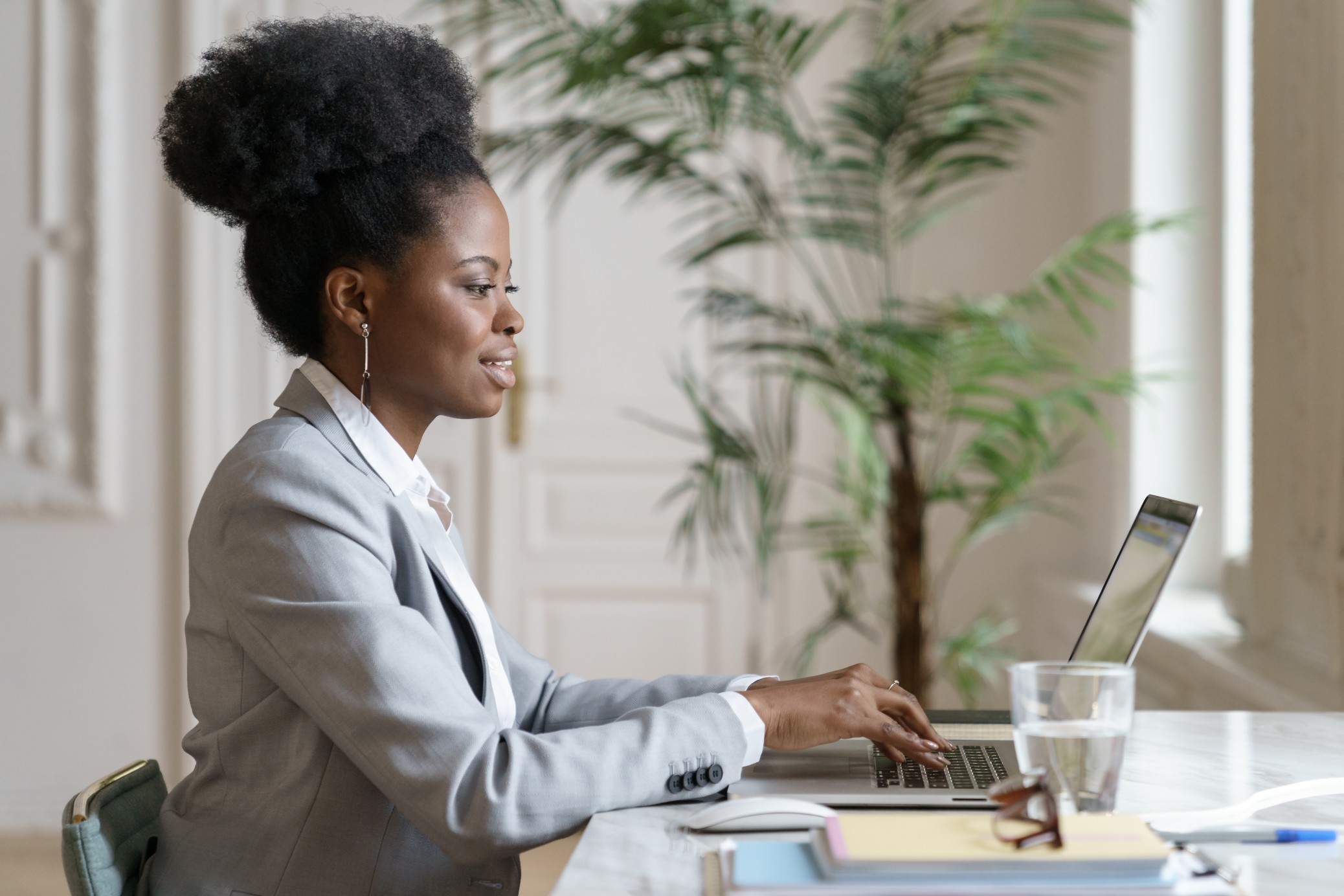 Black female therapist smiling and working at her desk in New York