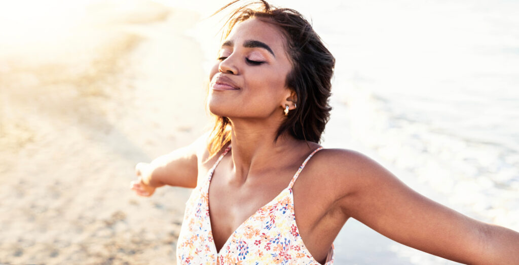 Free happy woman with open arms enjoying nature - Joyful black girl outdoors breathing fresh air - Enjoyment, freedom, happiness and mental health concept